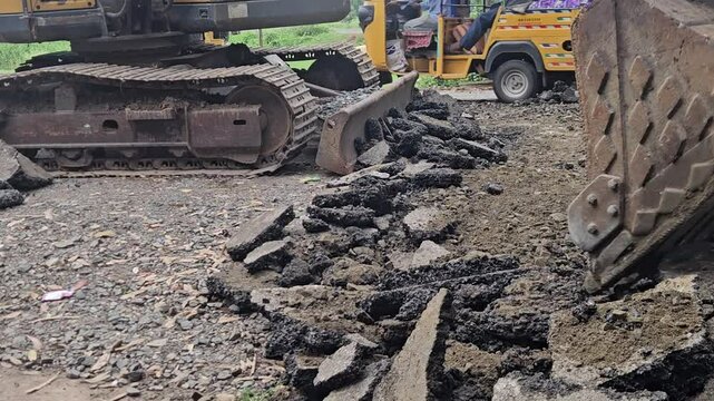 Construction site, large yellow heavy machinery like excavators, road building, and land development activities under the pressure of modern engineering and transportation demands.