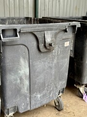 A Row of Industrial Waste Bins Equipped with Wheels for Easy Transportation and Use. A set of...