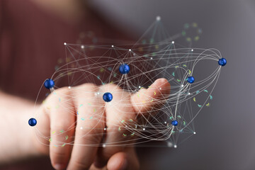 Hand interacting with a digital network.  Represents connection, technology, and innovation.