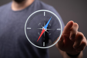 A man interacts with a digital compass, symbolizing guidance and direction in business.