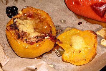 Close up of a filled stuffed pepper on baking paper just come out of the oven