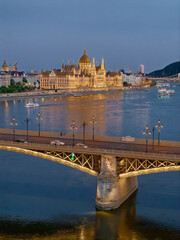 Scenic view of the famous Margit bridge acrossing over Danube river. Hungarian Parliament amazing building visible too in the photo