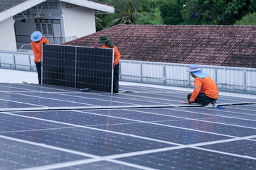 Engineer installing solar panels on wet metal rooftop during cloudy weather