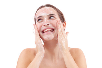 Close up of a happy smiling young woman washing her face, hands covered in foam touching her skin....