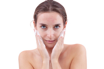 Close up of a young woman washing her face with hands covered in foam touching her skin. Deep...