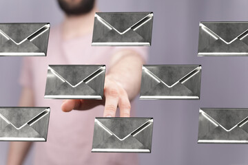 Abstract image of a hand reaching for floating email envelopes.  Perfect for communication or...
