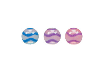 Three colorful marbles with wavy patterns are displayed against transparency background, showcasing blue, purple, and pink hues. marbles glossy surfaces reflect light, adding playful and vibrant