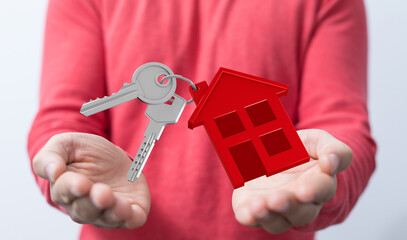 Person holding house keys.  Concept for real estate, homeownership, buying a house, new home,...