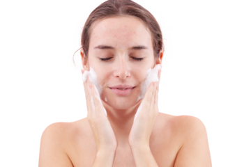 Close up of a young woman washing her face with hands covered in foam touching her skin. Deep cleansing skincare routine for clean, healthy skin. Isolated on white background, acne care concept