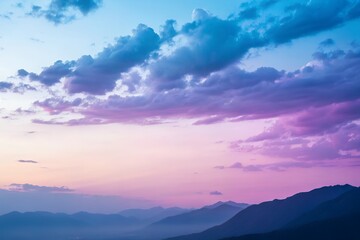 Obraz premium Pastel sunset sky over silhouetted mountain range