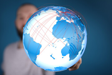 Stock photo of a person holding a digital globe, illustrating global connectivity and communication.