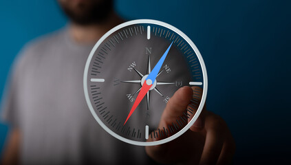 Image of a person using a digital compass, symbolizing guidance and direction.