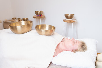 A meditative sound therapy session using Tibetan singing bowls. The sound waves produced are...