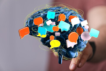Conceptual image of a brain with colorful speech bubbles, representing communication, ideas, and...