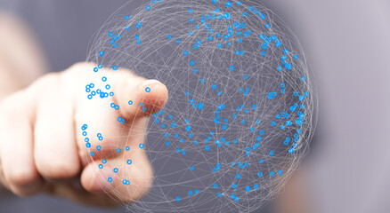 Abstract image of a hand interacting with a digital sphere representing global networking and...