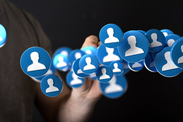 Abstract image of a hand interacting with a network of digital profile icons. Ideal for social...