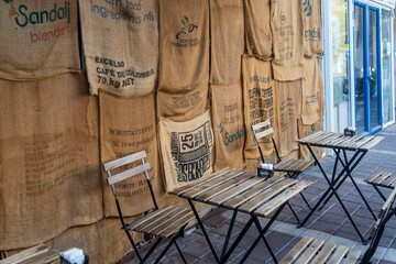 Petah Tikva, Israel, 12  JUNE 2025,  An Outdoor Cafe Area Decorated With Coffee Bean Sacks On The Wall.
