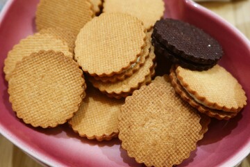 close up of chocolate and butter cream biscuits cookies sandwich on a plate