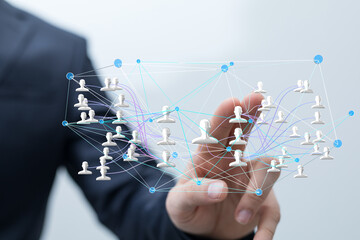 Image of a hand interacting with a network of people, symbolizing global connections and teamwork.