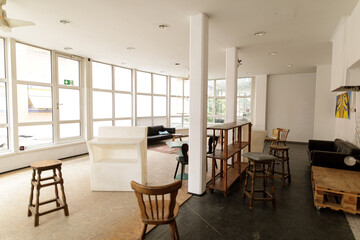 Stock photo of a bright, airy office space with large windows, minimalist furniture, and a modern design.