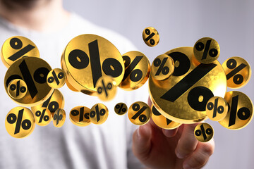 3D rendering of gold percentage symbols hovering near a person's hand, perfect for discount, sale,...