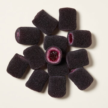 Cuberdons are dark purple jelly sweets with a jelly-like filling of currant or raspberry juice top view
