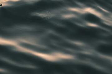 Golden blue sparkling water under the sunset