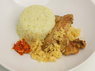 Savory rice served with fried chicken and chili sambal.