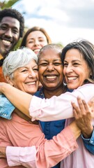 Happy diverse group hugging outdoors.