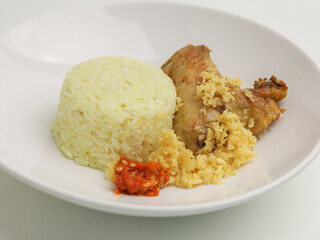 Savory rice served with fried chicken and chili sambal.