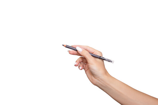 Female hand holding eyebrow pencil with brush for shading, isolated on white background. Self-care, beauty, fashion and makeup application concept
