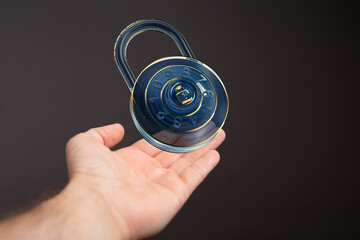 Secure your data.  Cybersecurity concept.  Image of a futuristic padlock in a hand.