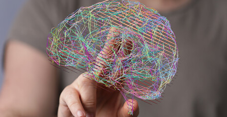 Stock photo of a hand interacting with a 3D brain model.  Perfect for AI, neuroscience, or...
