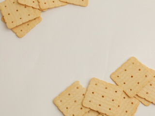 Square crackers piled on white background