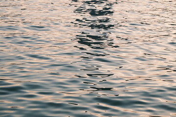 Golden blue sparkling water under the sunset