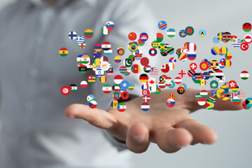 Image of a hand holding many different country flags, representing global connections and...