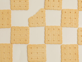 Square crackers piled on white background