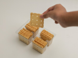Square crackers piled on white background