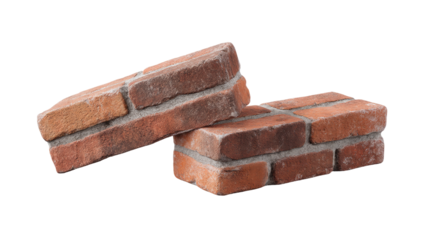 Two isolated red brick pieces on transparent background showing rough texture and mortar