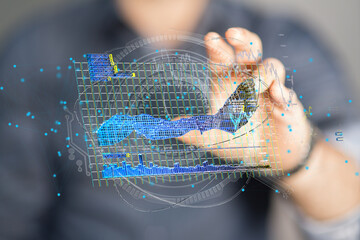 Stock photo of a hand interacting with a holographic display showing charts and graphs,...
