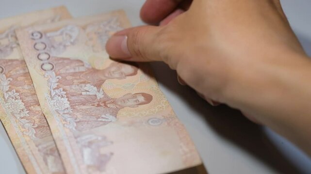 Close up shot of Thai baht Thailand cash currency THB bills and bank notes money economy.