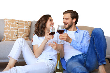 Happy couple sitting, relaxing on floor, drinking red wine. Smiling young husband and wife rest enjoy romantic date on family weekend together on a transparent background