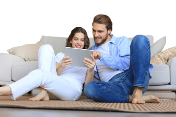 Happy couple sitting and planning new home decoration at home with a tablet, renovation and interior design for new house on a transparent background