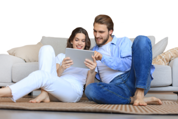 Happy couple sitting and planning new home decoration at home with a tablet, renovation and interior design for new house on a transparent background