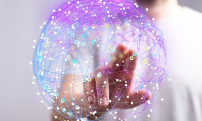 Abstract image of a hand interacting with a glowing network sphere.  Represents connection,...