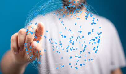 Person touching a digital network sphere, representing global connection and data interaction.