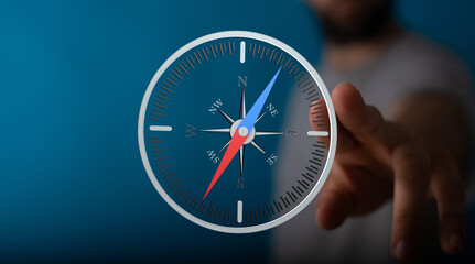 A man interacts with a digital compass interface, finding his way.  Guidance, direction, technology.