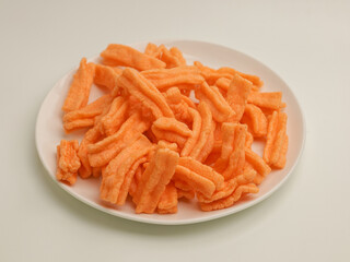 Savory rice crackers piled on white plate