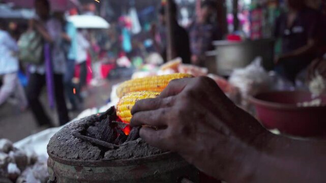 Roasting corn at food stall, Mumbai city, India