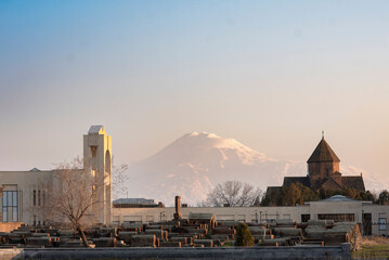 Sunlit Armenian church with Mount Ararat in the background at golden hour